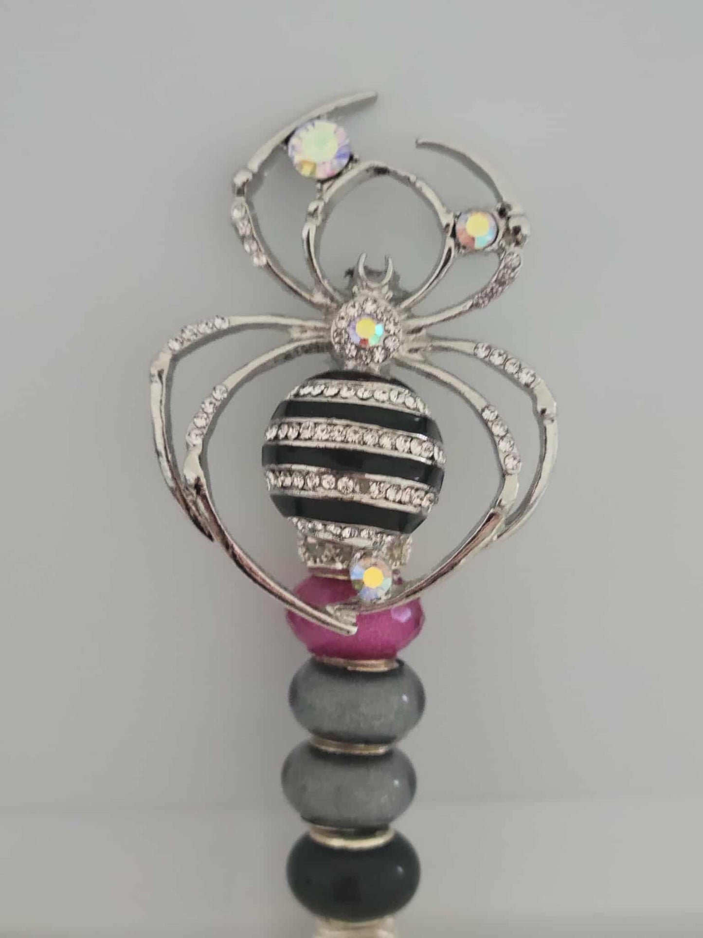 "Webbed Glamour: Handcrafted Spider-Themed Smoking Clip with Sparkling Elegance"