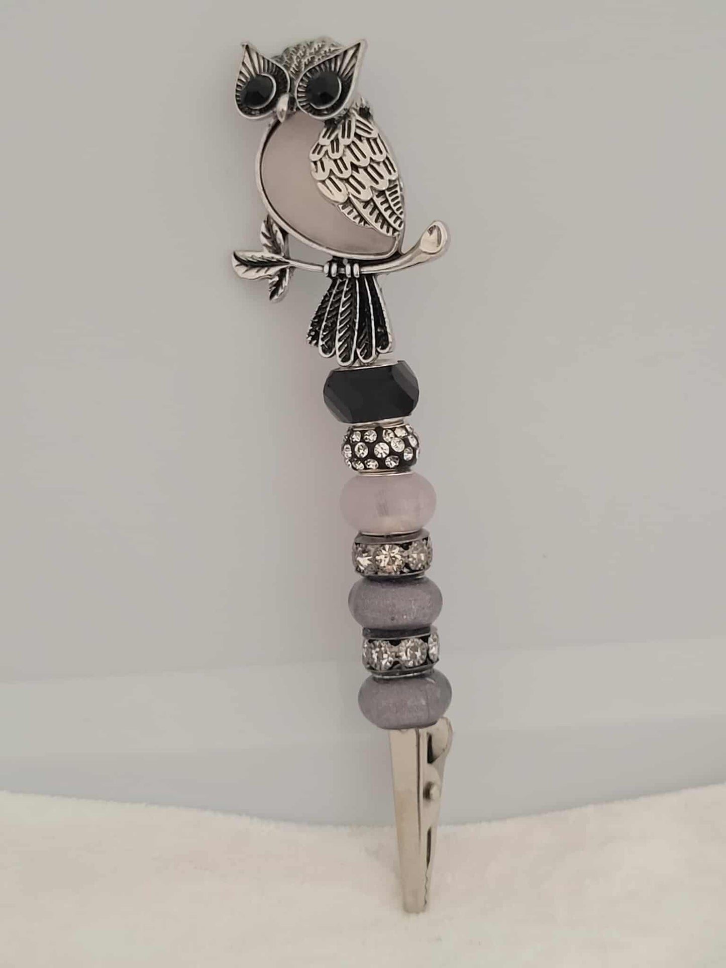 Decorative joint holder. Handmade Silver and opal owl roach clip with soft gray and opal-toned beads.
