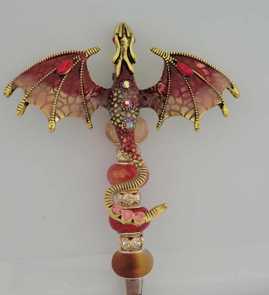 Decorative joint holder. Jeweled red and gold dragon roach clip with fiery red and bronze-toned beads.