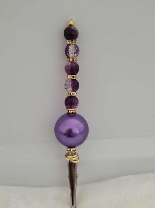 Decorative joint holder. Purple beaded roach clip with deep violet crackled beads and a sleek purple chunky bead and the bottom, with small gold rhinestone spacer beads.