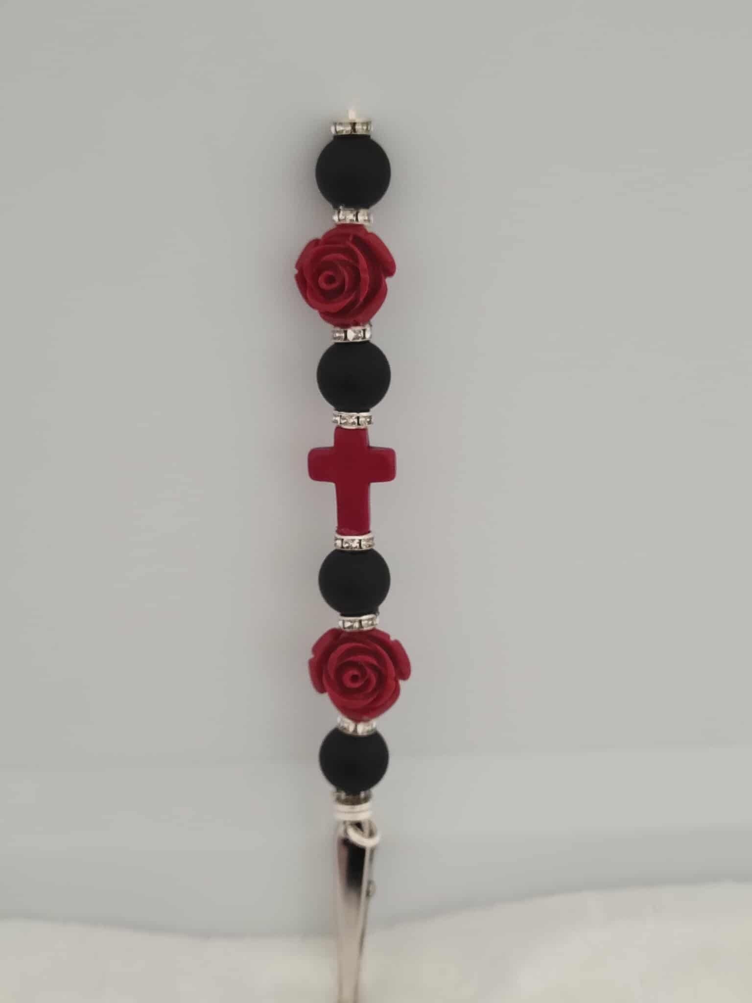 Decorative joint holder: Joint holder featuring matte black beads, crimson roses, shimmering rhinestone spacers, and a blood-red cross centerpiece.