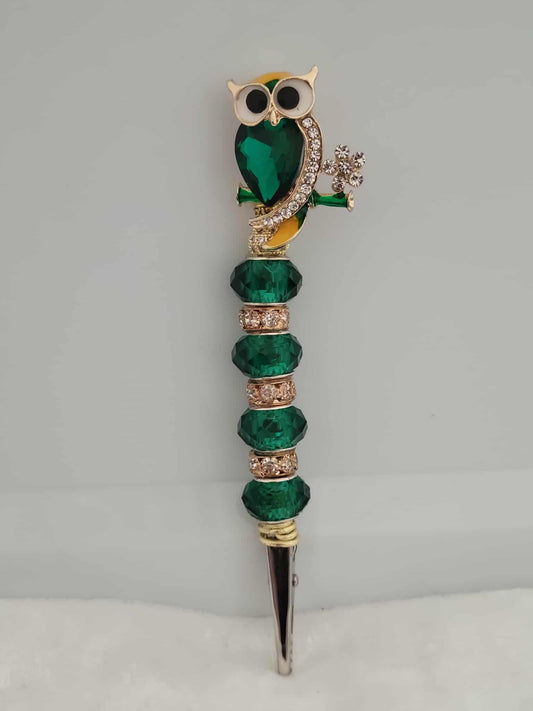 Decorative joint holder. Sparkling emerald owl roach clip, featuring emerald beads, sparkling rhinestone accents.