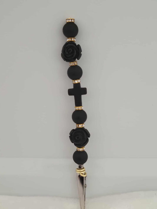  Decorative joint holder. Gothic handcrafted roach clip features matte black beads, jet-black rose accents, a central black cross, and gold rhinestone spacers.