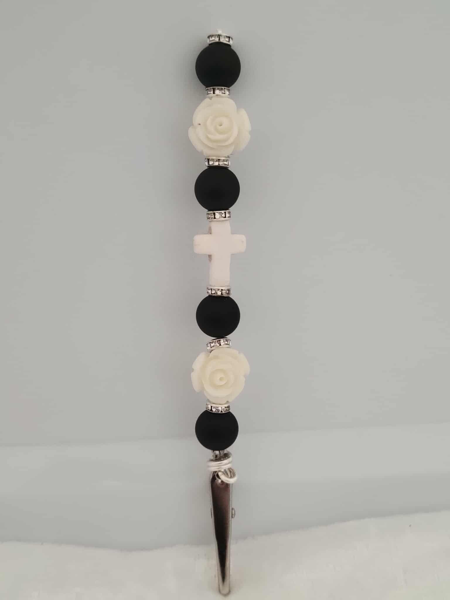 Decorative joint holder. Handcrafted black-and-white roach clip with matte black beads, ivory roses, small silver rhinestone spacers, and a soft white cross centerpiece.