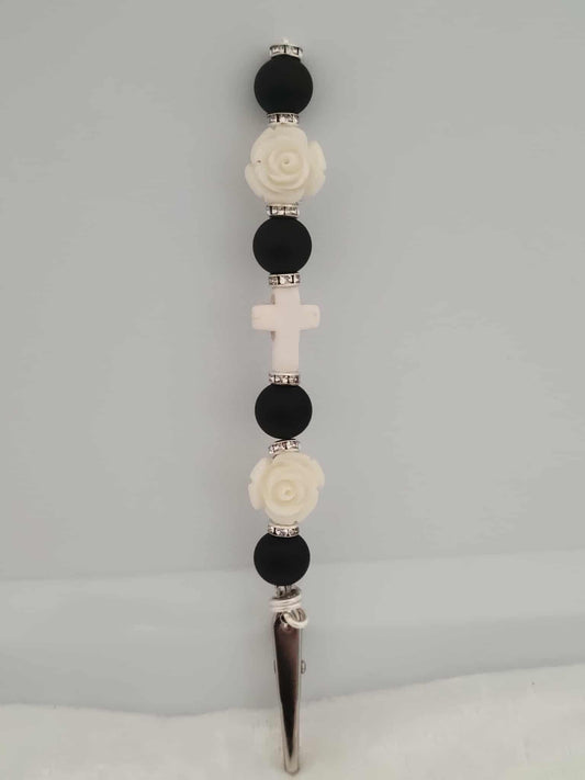 Decorative joint holder. Handcrafted black-and-white roach clip with matte black beads, ivory roses, small silver rhinestone spacers, and a soft white cross centerpiece.