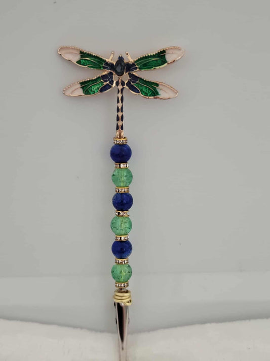 Decorative joint holder. Green and blue dragonfly roach clip with blue and green crackle beads and small gold rhinestone spacer beads.