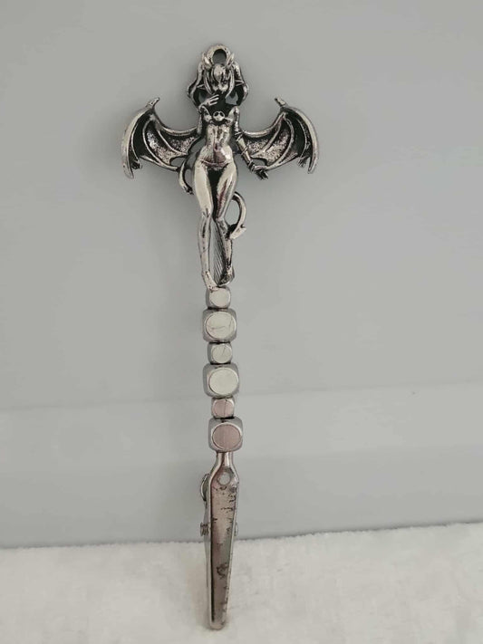Decorative joint holder. Sexy demon girl roach clip.  Demoness charm of a partially naked girl with horns on the top of her hair, she has silver bat like wings with a devil like tail whipped around her along with sleek silver cube beads.
