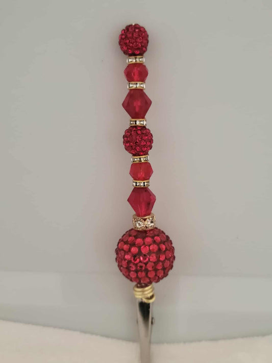 Decorative joint holder. Sultry roach clip is dripping in red rhinestones and glossy faceted beads.